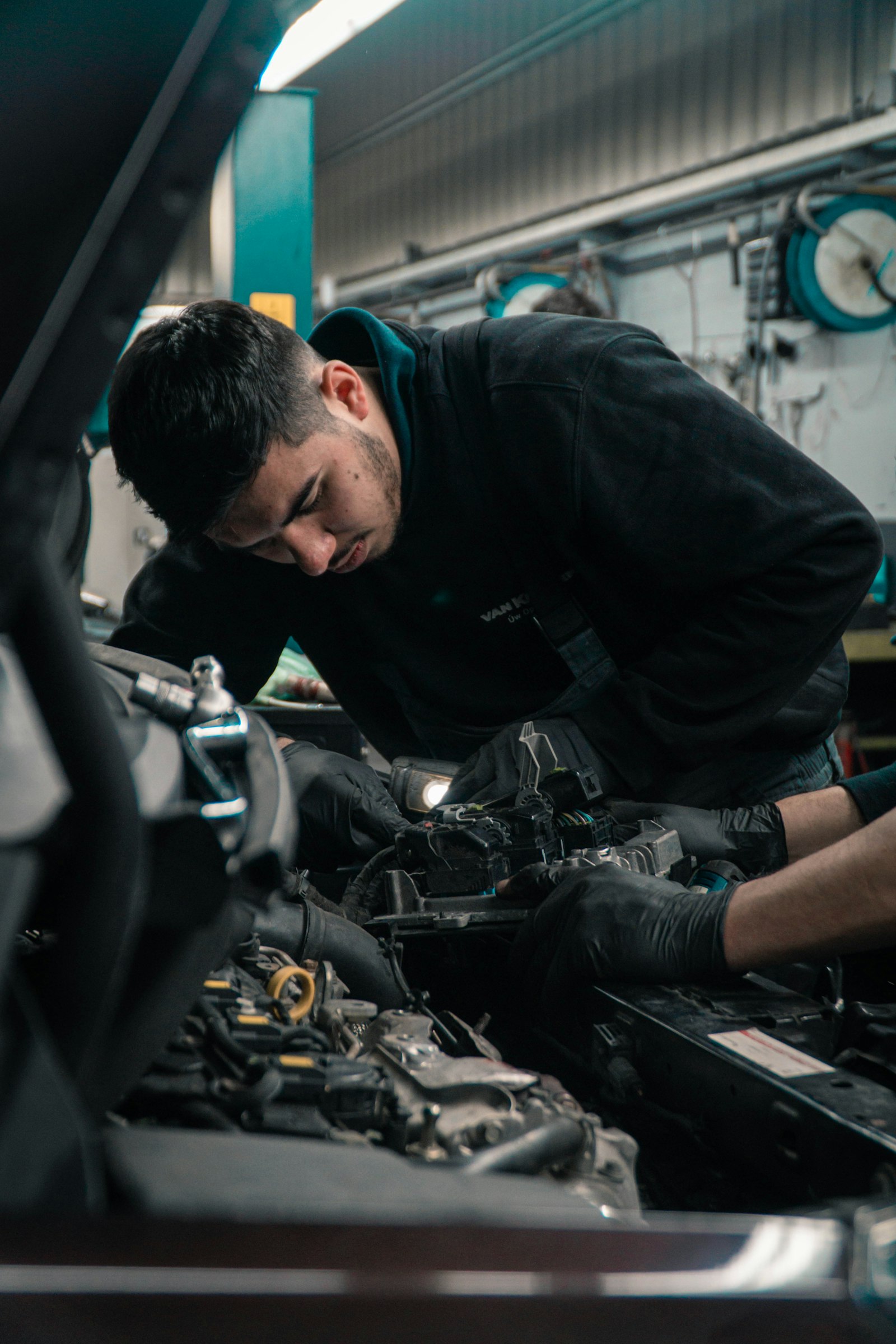 Technician performing diesel engine diagnostics on industrial equipment